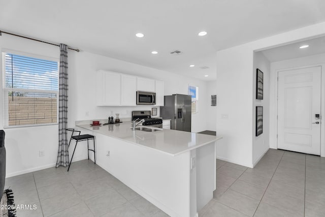 3309 E Malibu Dr, San Tan Valley, AZ 85143 - kitchen featuring visible vents, light countertops, appliances with stainless steel finishes, a peninsula, and white cabinetry