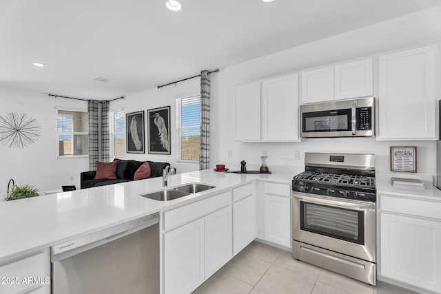 3309 E Malibu Dr, San Tan Valley, AZ 85143 - kitchen with light countertops, appliances with stainless steel finishes, a sink, and white cabinetry