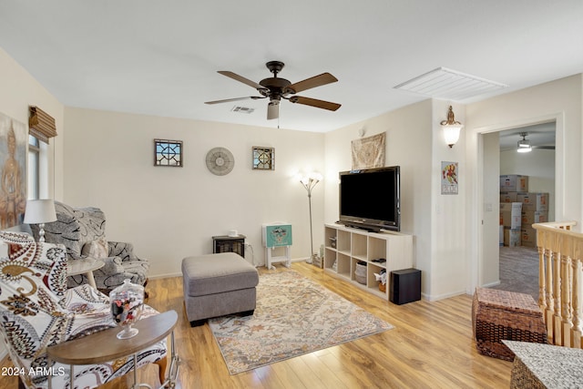 living room with light hardwood / wood-style floors and ceiling fan