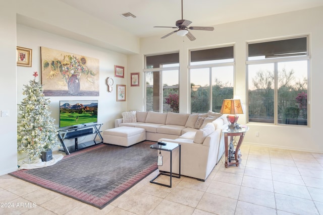 tiled living room with ceiling fan