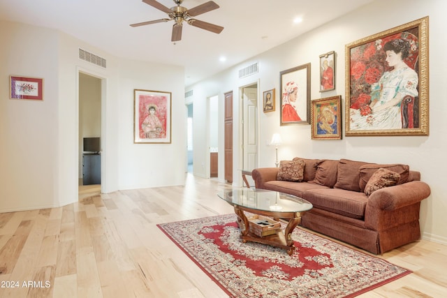 living room featuring hardwood / wood-style floors and ceiling fan