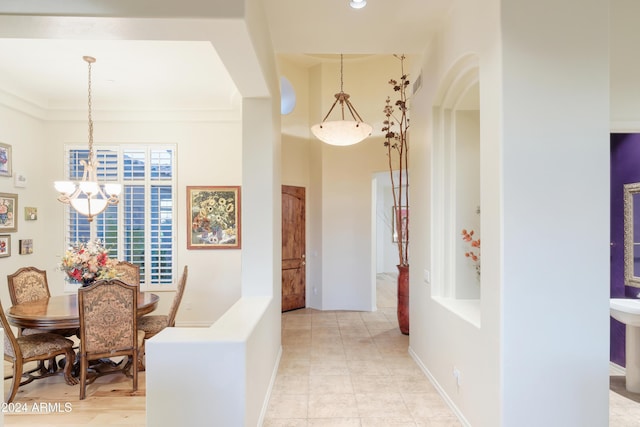 hallway with an inviting chandelier