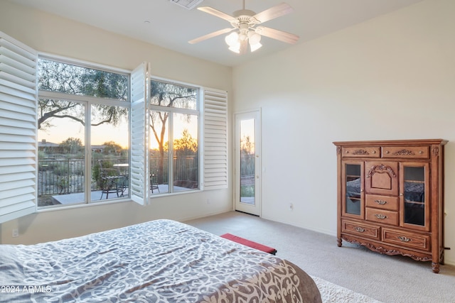 bedroom with access to exterior, ceiling fan, and light carpet