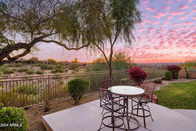 view of patio terrace at dusk