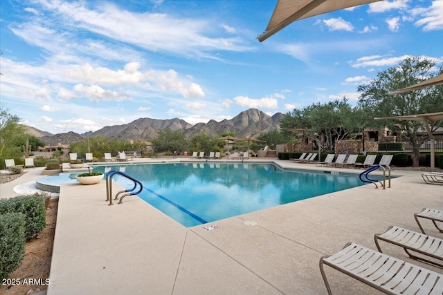 view of pool with a mountain view and a patio area