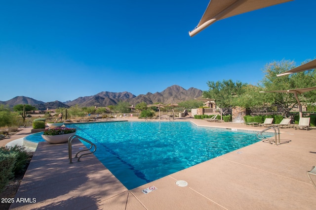 view of pool with a mountain view and a patio