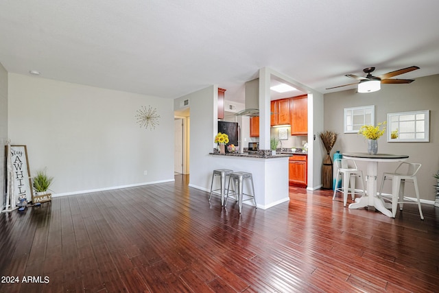 living room with ceiling fan and dark hardwood / wood-style flooring