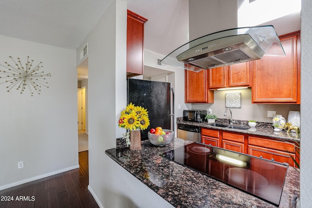 kitchen featuring sink, dark hardwood / wood-style floors, dark stone counters, island range hood, and black appliances