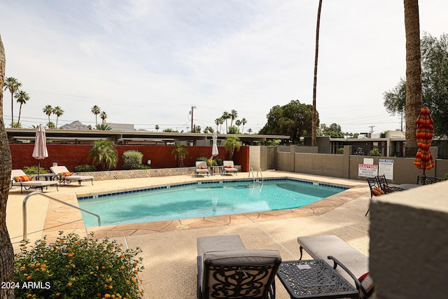 view of swimming pool with a patio area