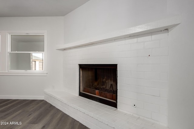 interior details featuring hardwood / wood-style floors and a brick fireplace