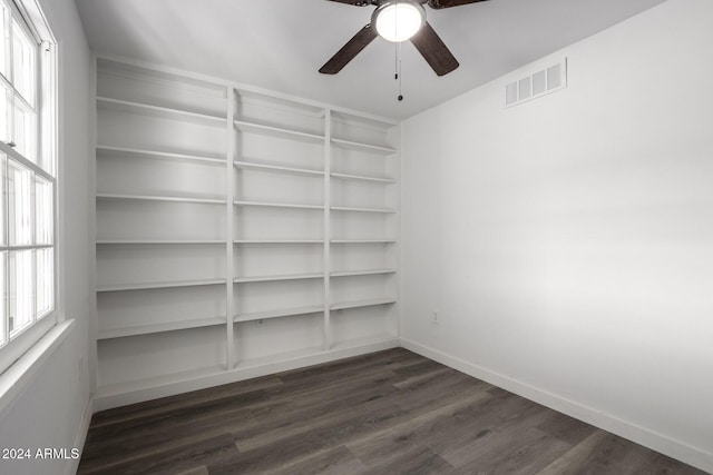 unfurnished room featuring dark wood-type flooring, ceiling fan, and a healthy amount of sunlight