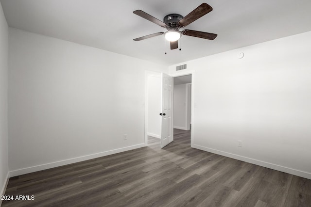 spare room with ceiling fan and dark wood-type flooring