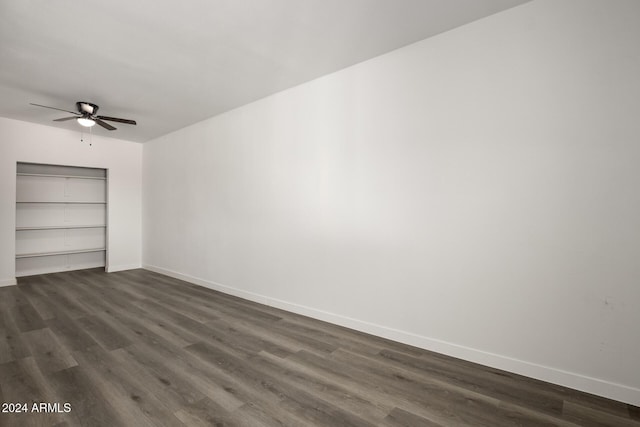 unfurnished room with ceiling fan and dark hardwood / wood-style flooring