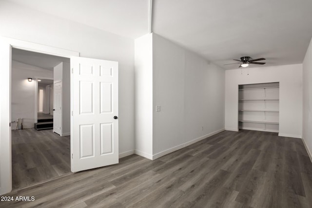 unfurnished bedroom featuring ceiling fan and dark hardwood / wood-style flooring