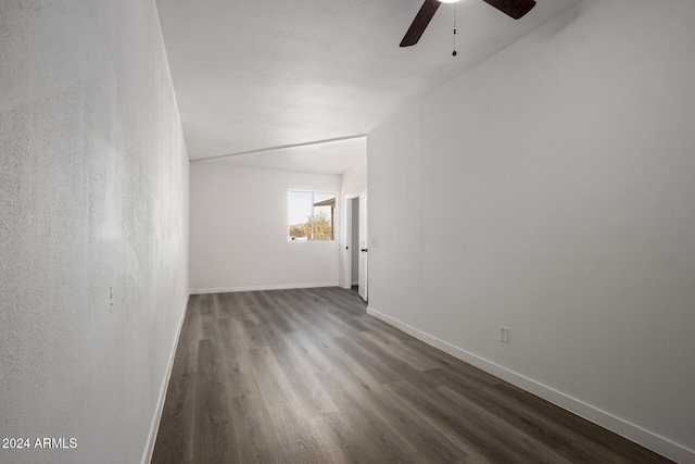 spare room featuring ceiling fan and dark wood-type flooring