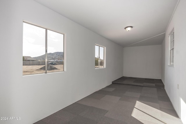 carpeted spare room with a mountain view