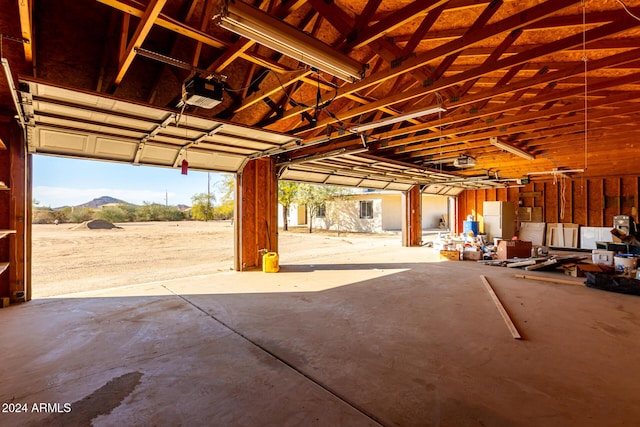 garage featuring a mountain view and a garage door opener