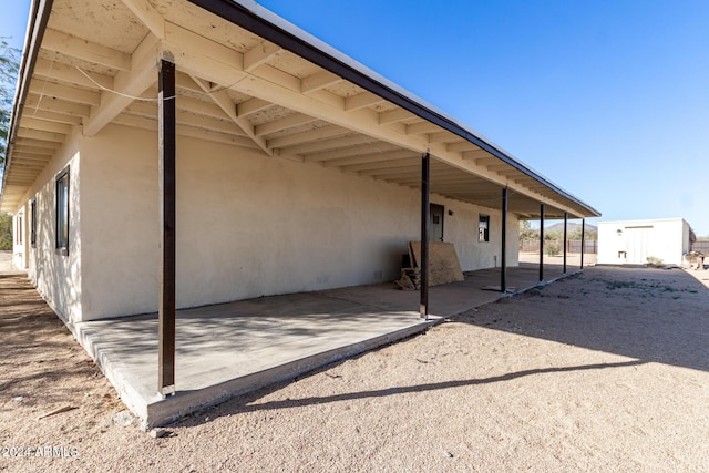 rear view of property featuring a carport