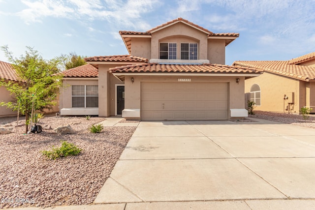 mediterranean / spanish-style home featuring a garage