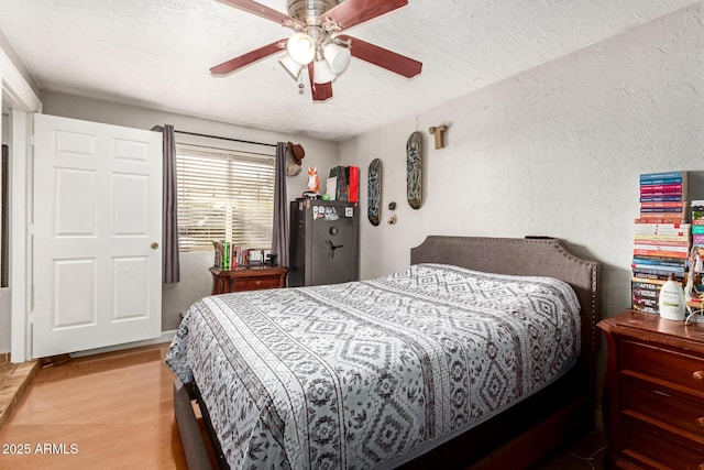 bedroom with ceiling fan and light hardwood / wood-style flooring