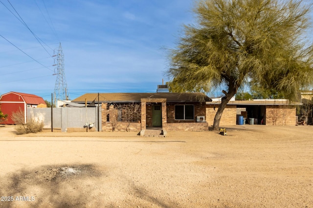 view of front of property with a storage unit