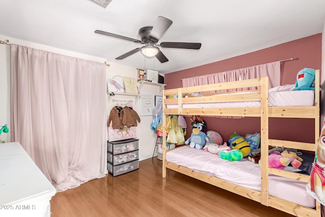 bedroom with ceiling fan and hardwood / wood-style floors