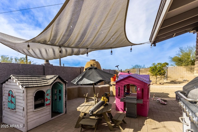 view of patio / terrace featuring a storage shed