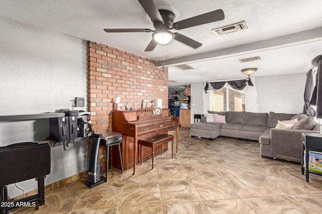 living room featuring ceiling fan and a textured ceiling