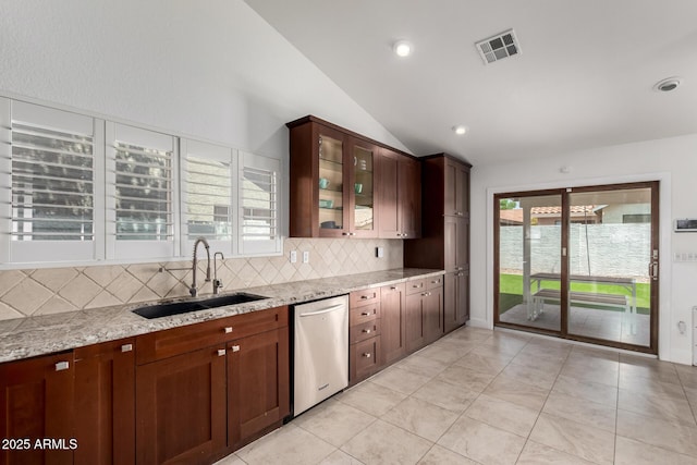 9100 E Captain Dreyfus Ave, Scottsdale, AZ 85260 - kitchen featuring stainless steel dishwasher, a sink, lofted ceiling, decorative backsplash, and light stone counters