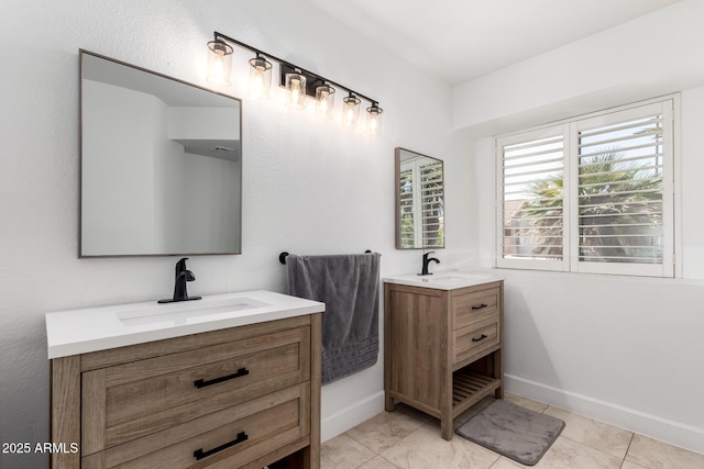 9100 E Captain Dreyfus Ave, Scottsdale, AZ 85260 - bathroom with two vanities, baseboards, and tile patterned floors
