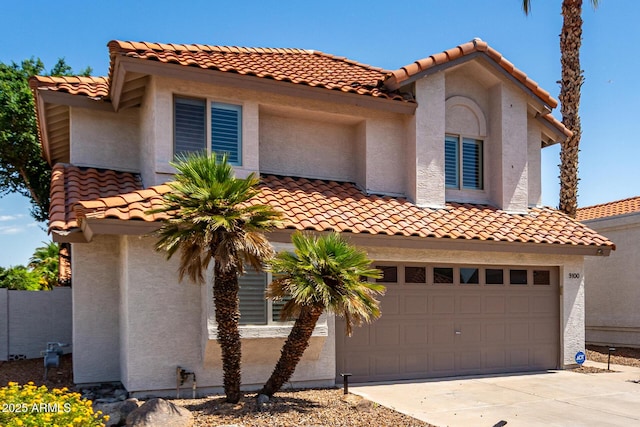 9100 E Captain Dreyfus Ave, Scottsdale, AZ 85260 - mediterranean / spanish-style home with a tile roof, stucco siding, concrete driveway, and a garage