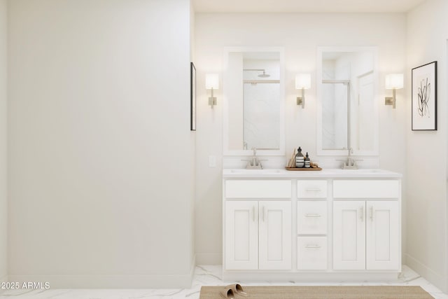 full bathroom featuring marble look tiles, a shower stall, baseboards, and double vanity
