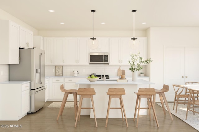kitchen featuring white fridge with ice dispenser, tasteful backsplash, light countertops, white cabinets, and recessed lighting