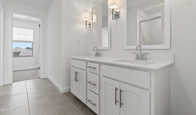 7420 S 76th Ln, Laveen, AZ 85339 - full bathroom featuring double vanity, baseboards, a shower with door, and tile patterned flooring