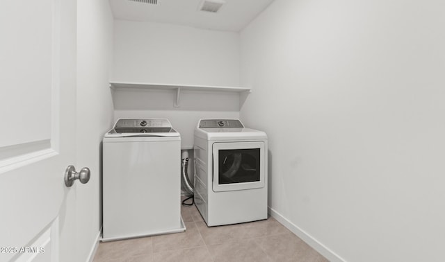 7420 S 76th Ln, Laveen, AZ 85339 - laundry area featuring washing machine and dryer, light tile patterned floors, and baseboards