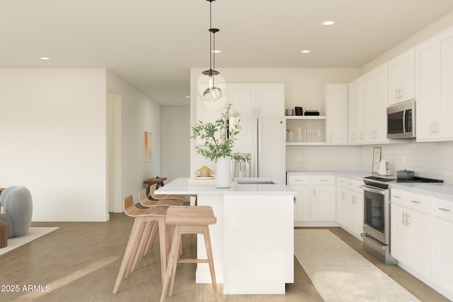 kitchen featuring appliances with stainless steel finishes, a kitchen island, decorative backsplash, open shelves, and white cabinetry