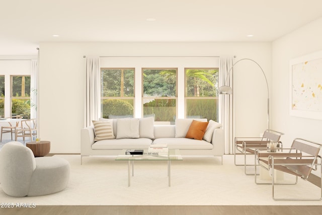 living room with healthy amount of natural light, wood finished floors, and recessed lighting