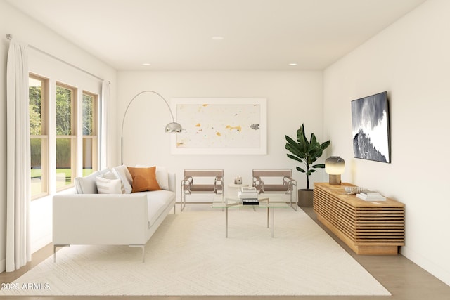living area with baseboards, recessed lighting, and wood finished floors