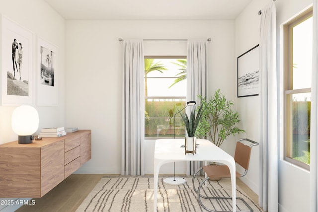 living area featuring wood finished floors, plenty of natural light, baseboards, and an office area