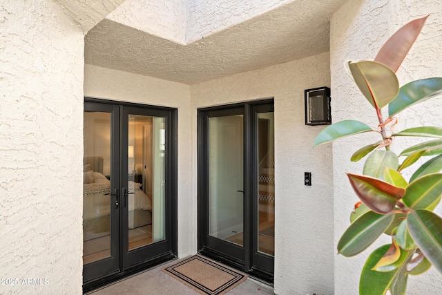 view of exterior entry featuring french doors