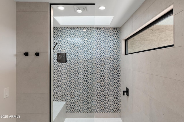 bathroom with tiled shower