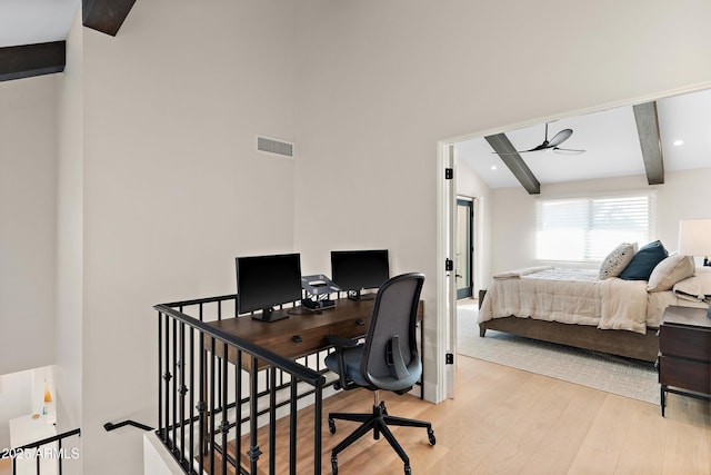 bedroom with beamed ceiling and light hardwood / wood-style flooring