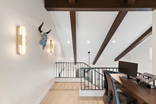 home office with beam ceiling and light hardwood / wood-style floors