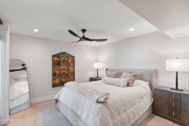 bedroom with ceiling fan and light hardwood / wood-style flooring