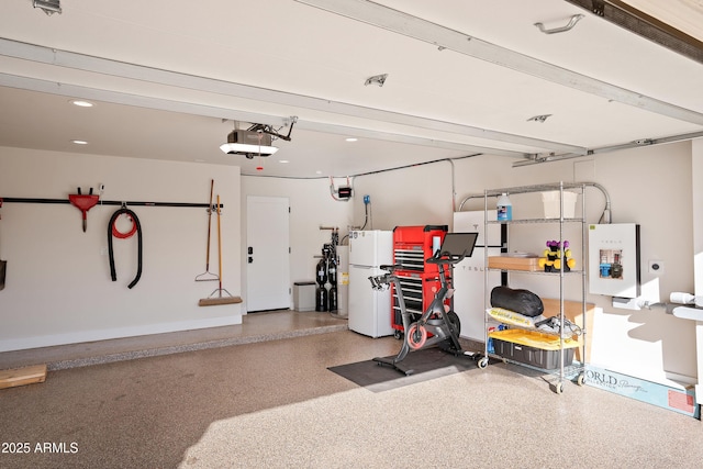 garage with white refrigerator and a garage door opener