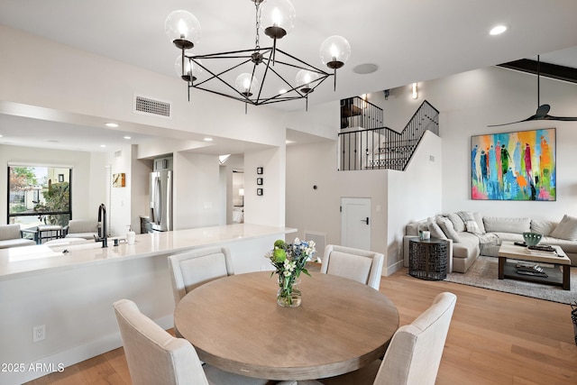 dining area with sink and light wood-type flooring