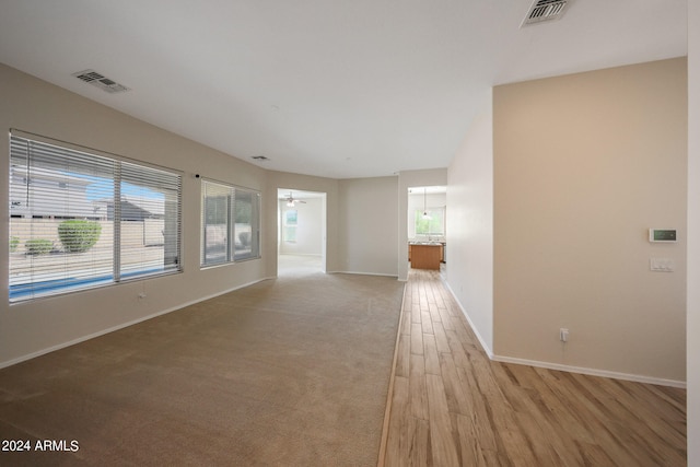 empty room featuring ceiling fan and light wood-type flooring