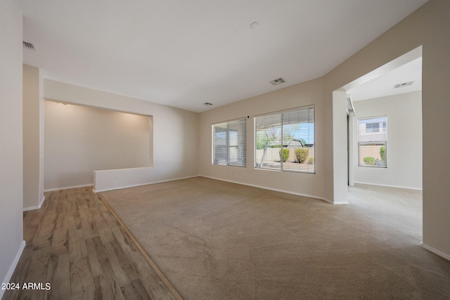 spare room featuring plenty of natural light and light hardwood / wood-style floors