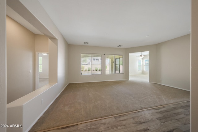 carpeted empty room with ceiling fan