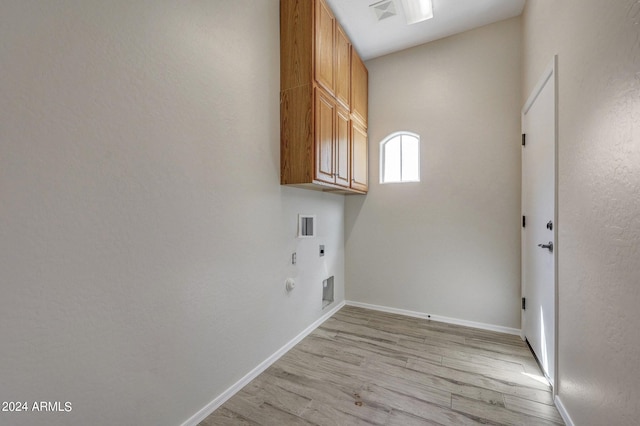 washroom with hookup for an electric dryer, washer hookup, hookup for a gas dryer, cabinets, and light hardwood / wood-style floors